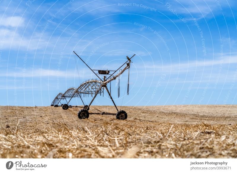 Irrigation system standing on a dry field in Alentejo, Portugal farm water irrigation pivot catastrophe disaster natural industry stubble portugal alentejo rows