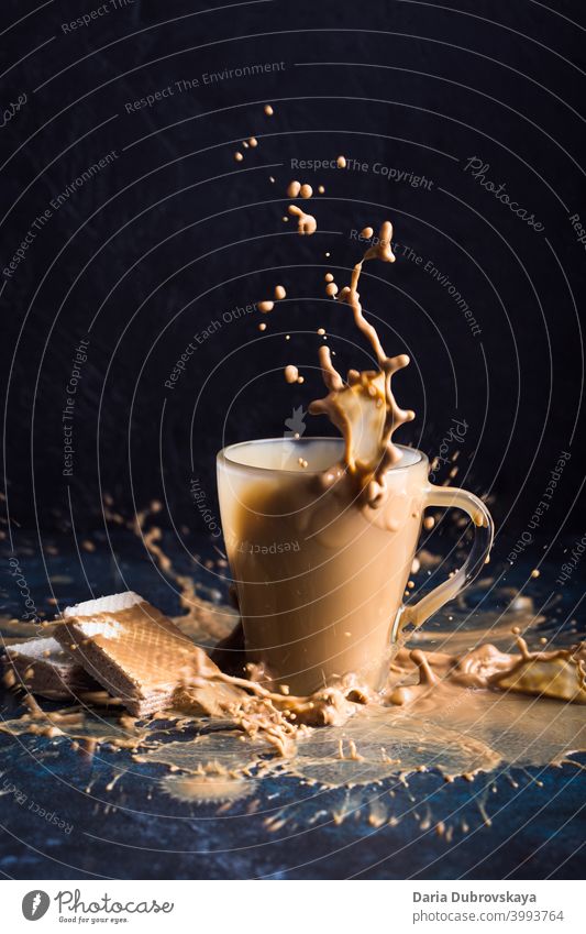 Splash of coffee with milk cup splash sweet fresh background drink black cool glass nobody beverage caffeine cold chocolate detail closeup cafe take flavor food