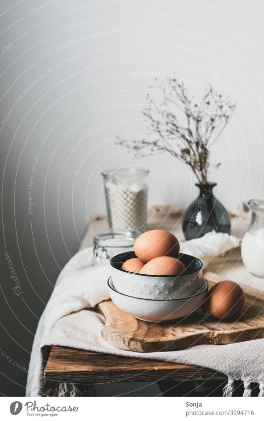 Eggs in a bowl and baking ingredients on a kitchen table. Rustic. eggs bowls Kitchen Table Ingredients Baking Still Life Food Nutrition Preparation Breakfast