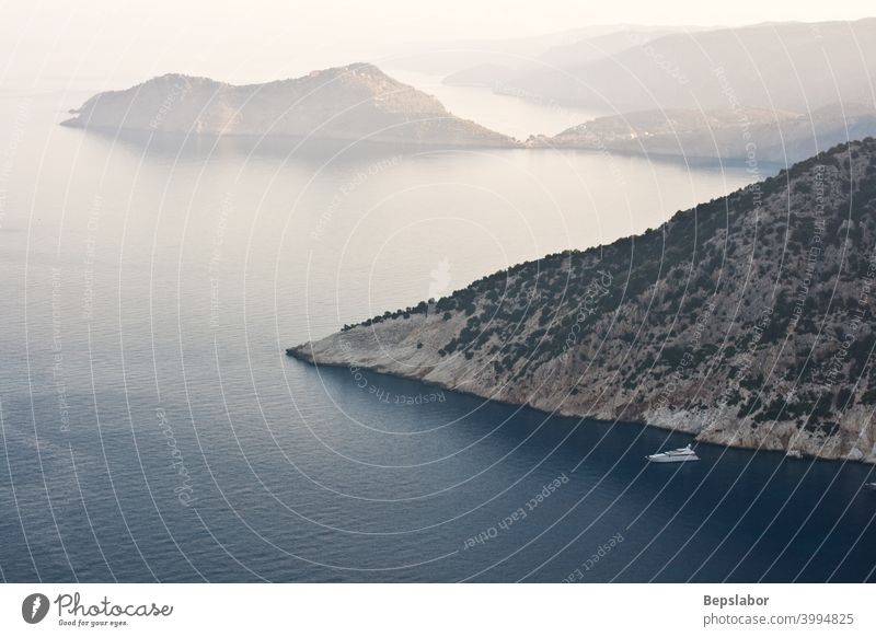 View of Assos immersed in the morning fog. It's an island of Cephalonia in western Greece outlook plunge reef bathe crystal crystalline mist swim greece ionian