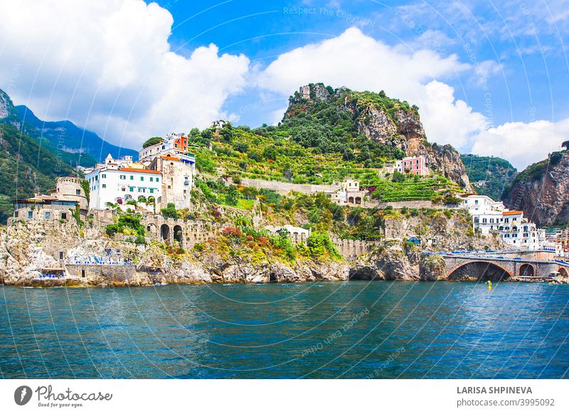 Panoramic view, aerial skyline of small haven of Amalfi village with tiny beach and colorful houses located on rock. Tops of mountains on Amalfi coast, Salerno, Campania, Italy