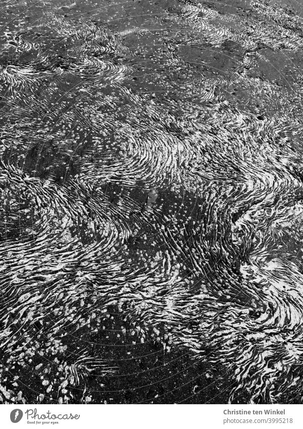 Asphalt with wavy structures accentuated by light sand Structures and shapes Pattern Sand Undulation Abstract Detail Light Close-up Contrast Bird's-eye view