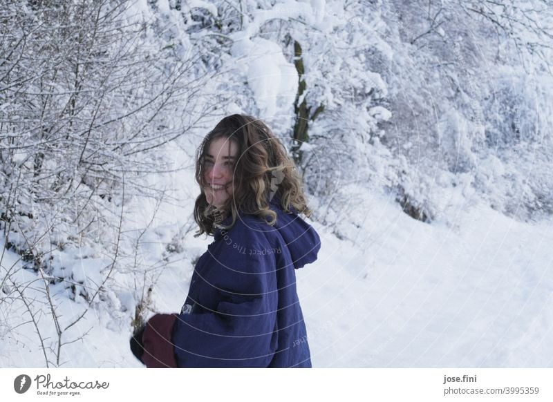 Young woman with warm clothes, laughing, snow in background. one person young adult Girl Youth (Young adults) Feminine portrait pretty Fresh naturally Authentic