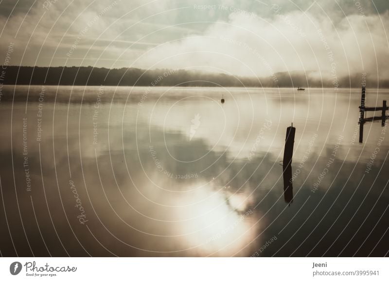 Fog over the lake in the early morning | Small fishing boat glides through the foggy morning Lake Water Calm Nature Moody Landscape Morning Dawn Sunrise Sky