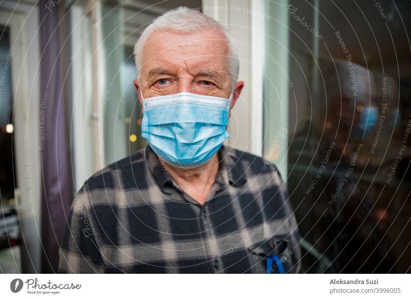 Senior man in protective mask staying home during pandemic lockdown. adult aged assistance breathing care coronavirus covid-19 disease distance elderly epidemic