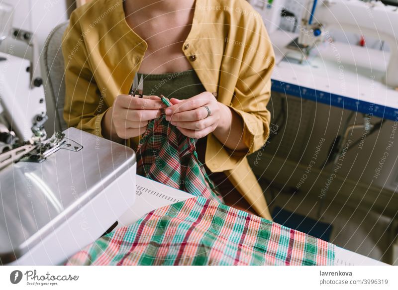 Faceless portrait of female tailor working in her workshop woman girl sewing person business professional occupation job self-employed casual studio owner