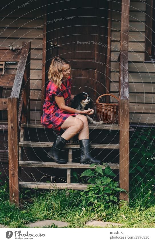 happy woman sitting on porch of her wooden country house. Rural living, running away to nature, ecology concept summer adult female home casual countryside girl