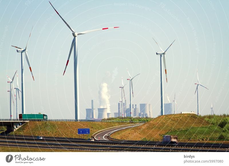 New motorway with feeder roads at the opencast lignite mine Garzweiler 2. Wind turbines in the foreground, lignite-fired power plant Neurath in the background. TRUCK