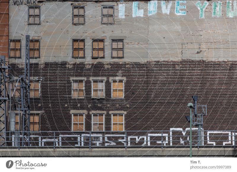 a facade with nailed windows and graffiti in Berlin Facade Friedrichshain Capital city House (Residential Structure) Exterior shot Building Downtown