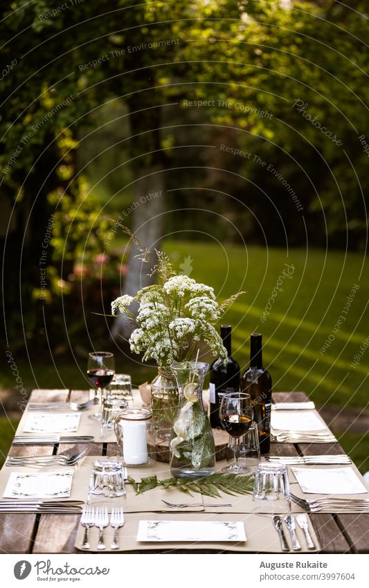 Served restaurant table outdoors Food table Table Restaurant Wine Wine glass wineglass Wine tasting Watering can Fork knife Glass Glassbottle Flowers and plants