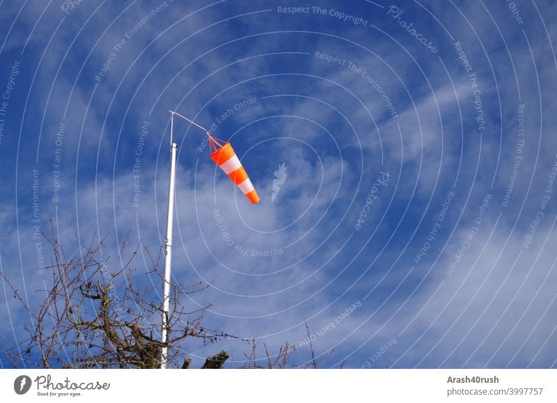 Waving windsock under blue sky Windsock Sky Blue Clouds Nature outside Orange-white Blow Warn Sign