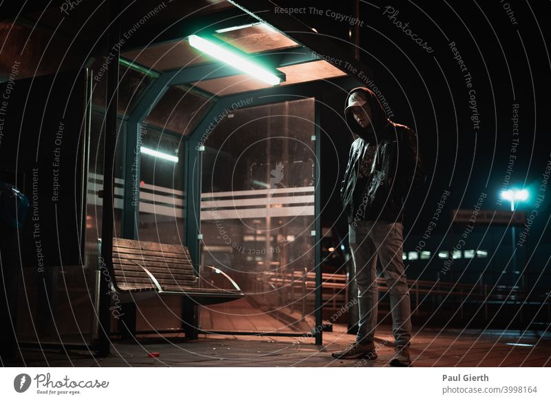 Man alone at the bus stop at night by oneself Dark portrait Light Shadow Night Exterior shot Deserted Lighting Artificial light Street lighting Contrast