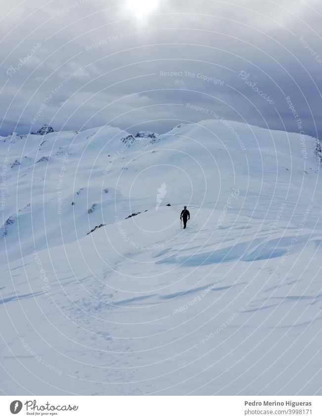 Snowy mountain with the silhouette of a person male peak freedom nature sun target snowy climber clear people high snow-covered mountaineer extreme environment