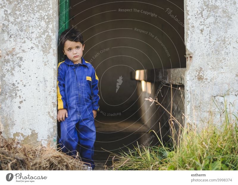 sad and pensive child next to a door childhood nostalgic thoughtful kid loneliness lonely expression freedom innocence unhappy portrait serious dream bored