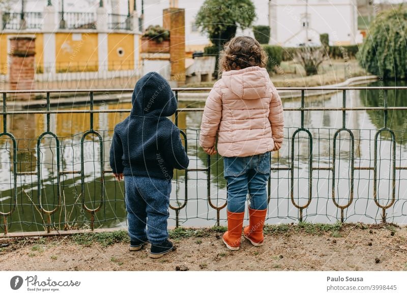 Brother and sister watching lake Brothers and sisters brothers Family & Relations Rear view Unrecognizable Authentic casual Together Friendship Colour photo