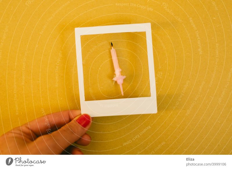 Blown out birthday candle in polaroid frame blown out Polaroid over Birthday Memory birthday party Hand feminine Yellow shoulder stand Pink Expire