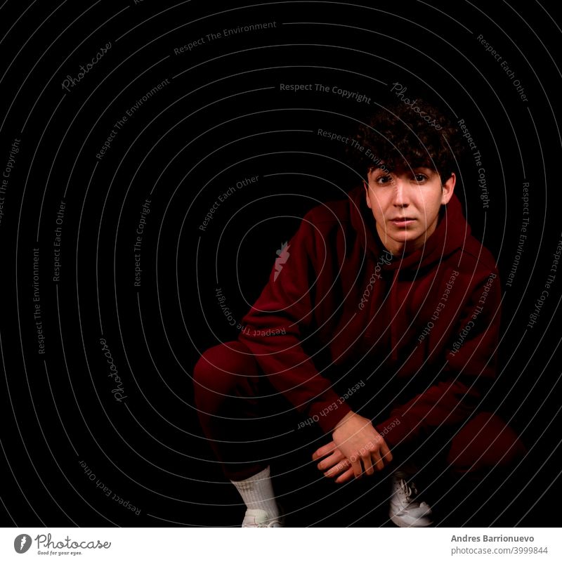 Attractive young man with curly hair posing on black studio background caucasian closeup thoughtful guy looking people short attractive beauty haircut fashion