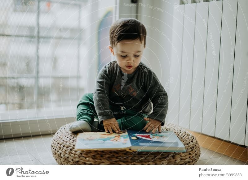 Toddler reading a book at home Child childhood 0 - 12 months 1 - 3 years Caucasian Reading Book Education educational Joy Happy Cute Lifestyle Human being Baby