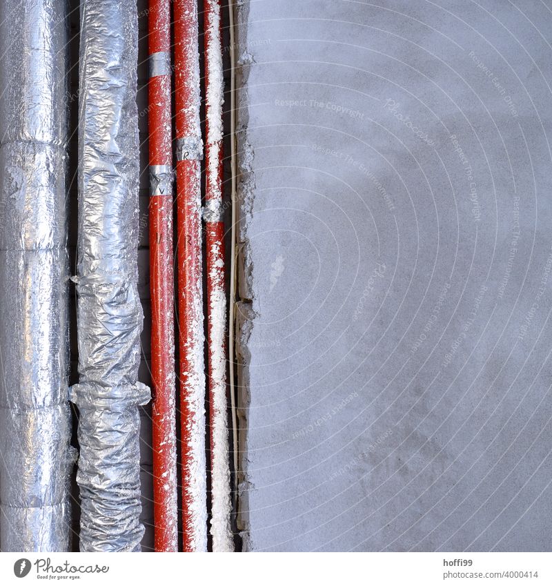 Pipes and lines in a shell shortly before plastering unfinished Construction site reeds Cables Laying cables Plaster Connection water pipe Provision