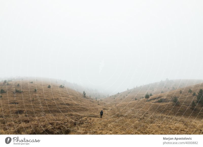 Young man exploring nature on a wet winter morning in the mountains adventure alone autumn beautiful challenge cold europe exploration explore explorer fog