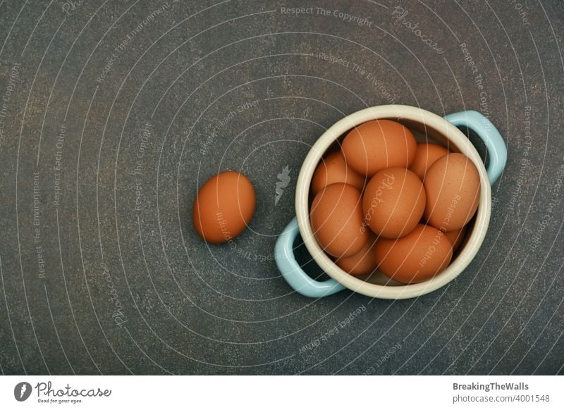 Bowl of brown chicken eggs on table Eggs fresh bowl pan pannikin metal group one many grunge dark closeup copy space food healthy natural eating cooking high