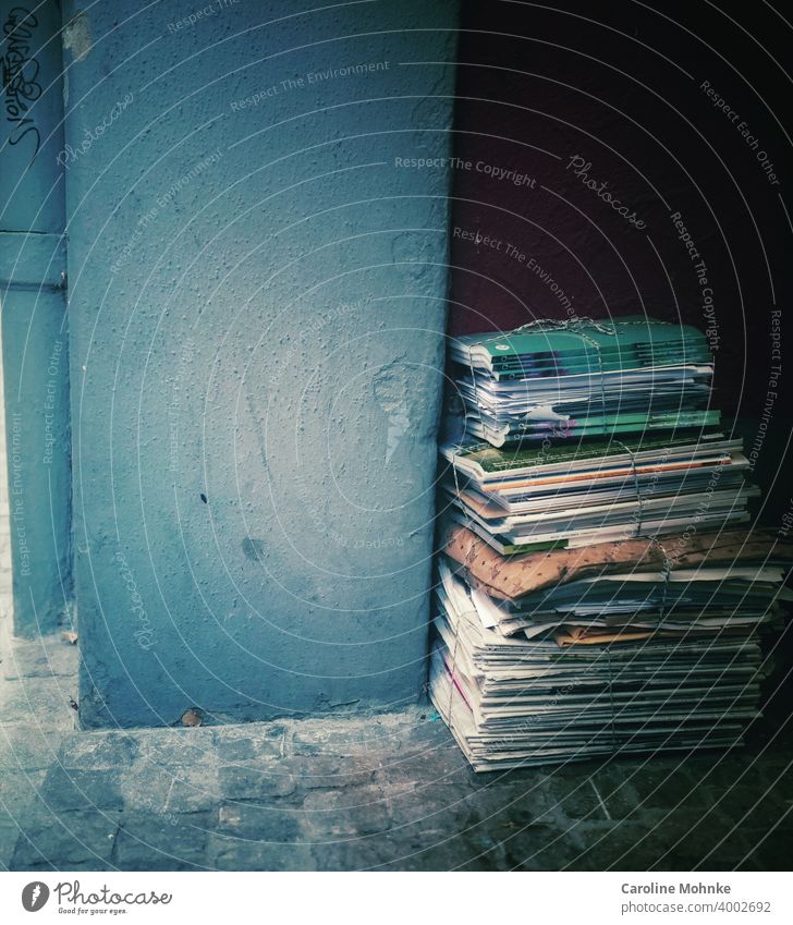 Piles of newspapers bundled against a house wall Waste paper Paper Stack Recycling Colour photo Newspaper Media Print media Magazine Information Education