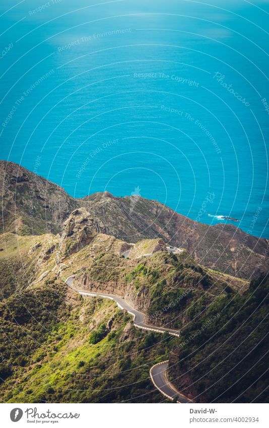 winding road leads through the mountains directly by the sea Street curvaceous Ocean Landscape Target burdensome hilly Hilly landscape ocean Lanes & trails