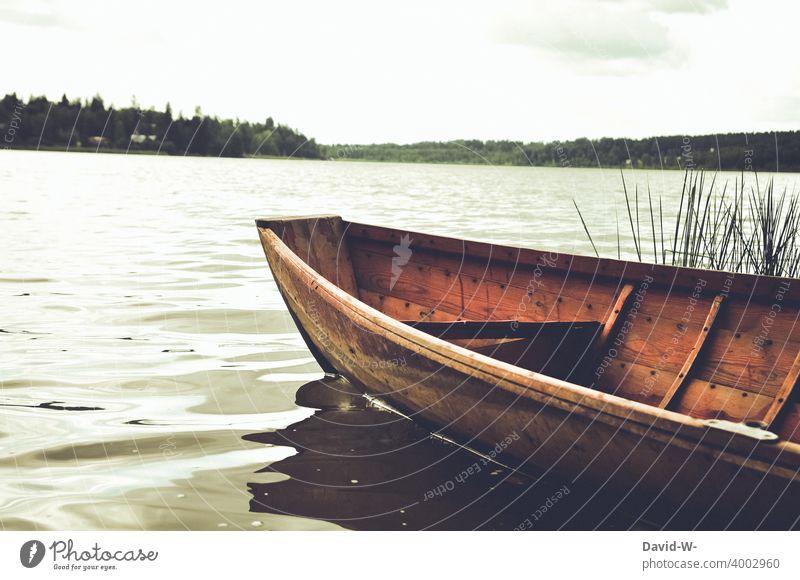 Rowing boat on the shore of a lake Rowboat Lake Adventure Far-off places Nature Vacation & Travel Lakeside Calm tranquillity euphoric mood