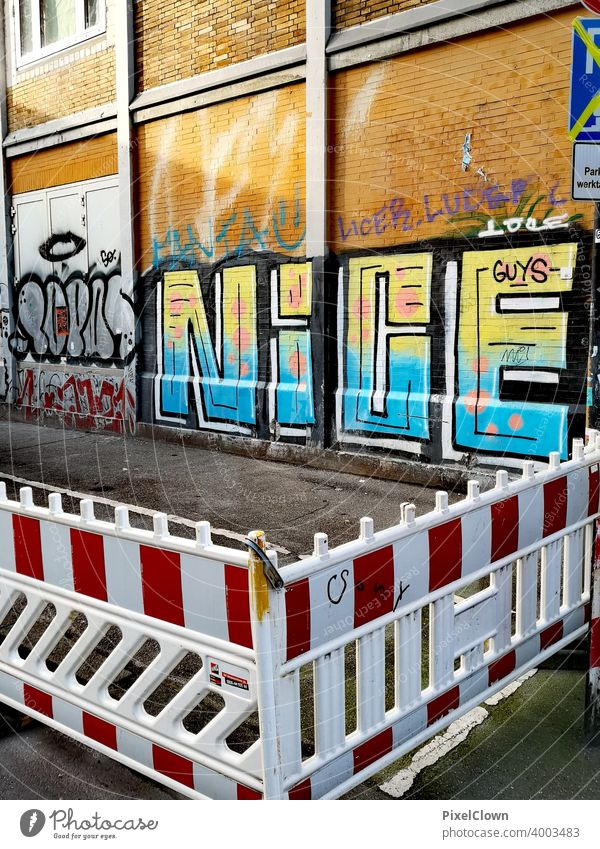 Construction site with a wall with graffiti Scaffolding Facade Redecorate Modernization Graffiti Structures and shapes Letters (alphabet) Redevelop Street art