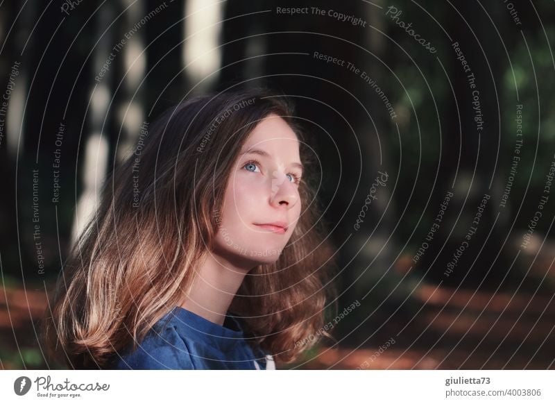 Portrait of a teenage girl in the forest, 13 years old, smiling and hopeful about the future portrait Central perspective Shallow depth of field blurriness