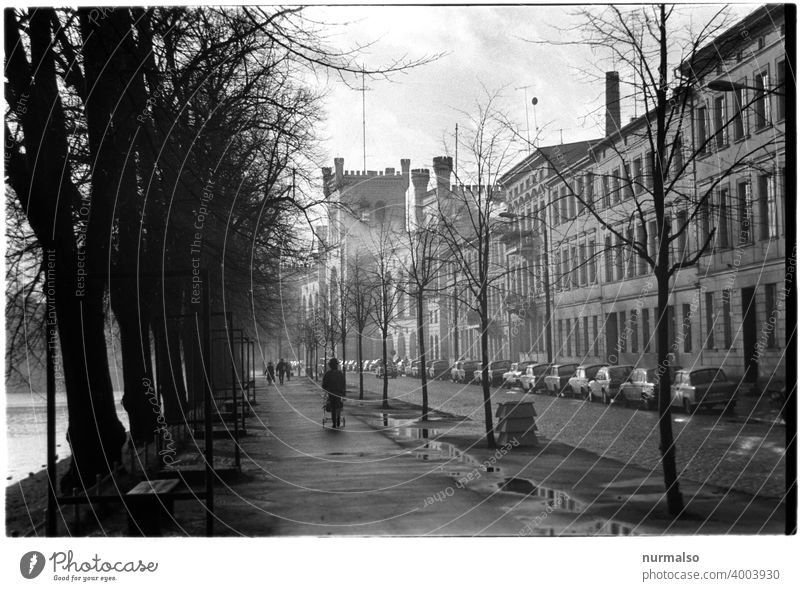 Schwerin 1990 Pfaffentwich schwerin.winter Turnaround Baby carriage Mecklenburg Lake Street cobbles Trabbi trobant arsenal trees leafless Gloomy Cold Monochrome