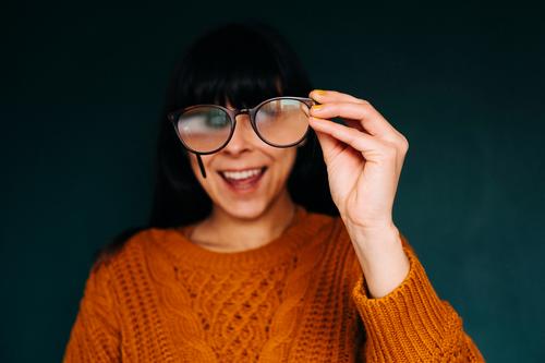 Woman looking through glasses while laughing Eyeglasses Laughter Funny foolish see hazy Enlarged Qautsch Grimace Face Eyes Joy