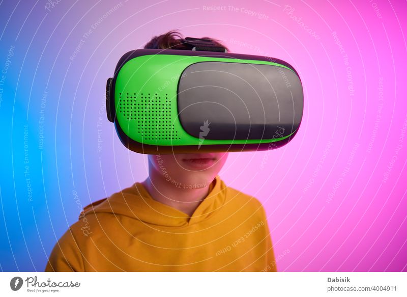 Boy with virtual reality glasses on colorful background. Future technology, VR concept vr headset boy helmet device game future video experience wearable