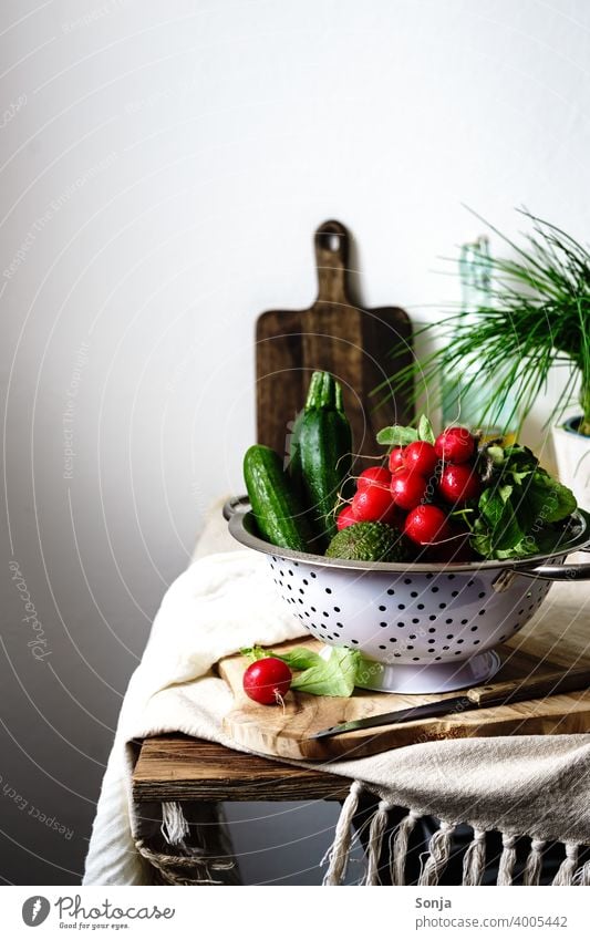 Still life of vegetables in a colander on a kitchen table Vegetable Radish Green Sieve Still Life Vegetarian diet Rural Organic produce Fresh Healthy Eating