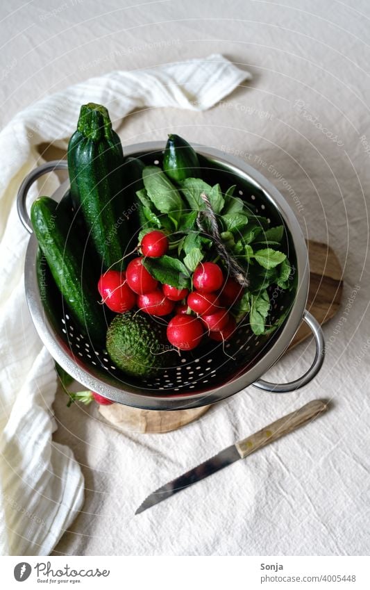 Radishes and green vegetables in a colander on a beige linen tablecloth Vegetable Green Raw Sieve Linen Healthy Food Vegetarian diet Organic Fresh Diet Rural