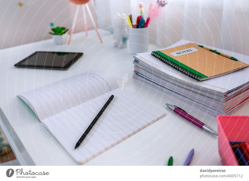 Desk in girl's bedroom decorated in pastel colors white desk closeup homework nobody girls bedroom nordic decoration style notebook childish chic design