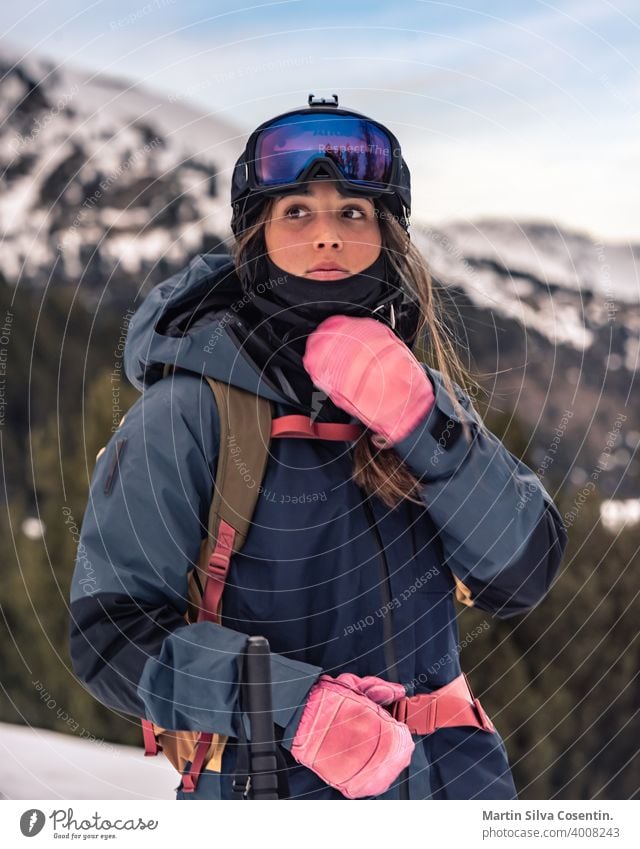 Young skier with her off-piste skis in winter on a sunny day action active agility air clothing cold competiting competition cool dangerous dolomite downhill