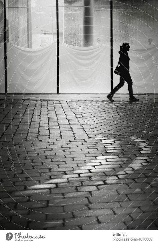 City stroll with shuttered shop windows and a curve Shopping center Shop window overcast Human being person Woman young girl Way to work on one's own Shops Load