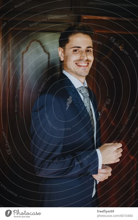 Portrait of a young groom on his wedding day smiling at camera portrait marriage engagement people attractive copy space looking at camera man male 20s 30s blue