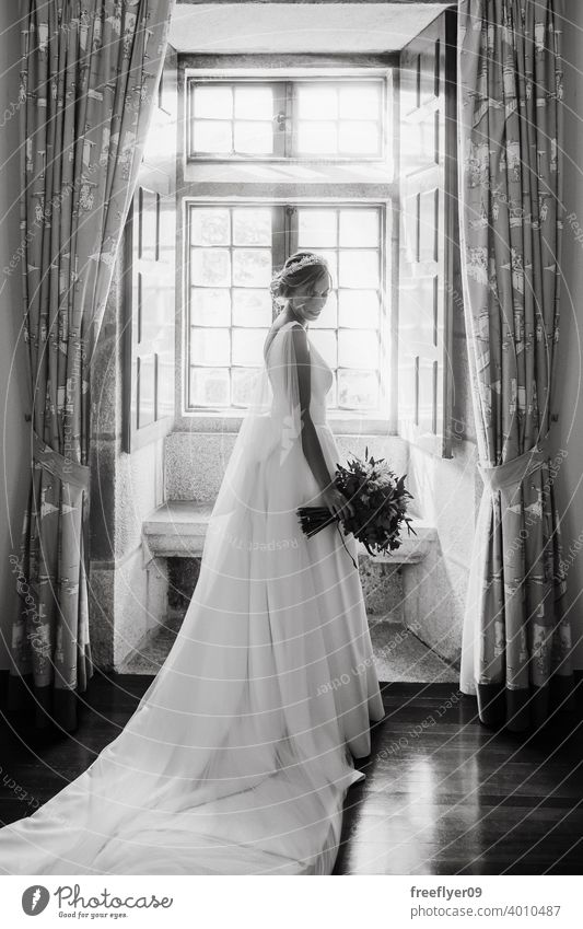 Bride on her wedding dress in front of a window marriage bride love woman fine elegance caucasian person beauty female femininity portrait event romance human