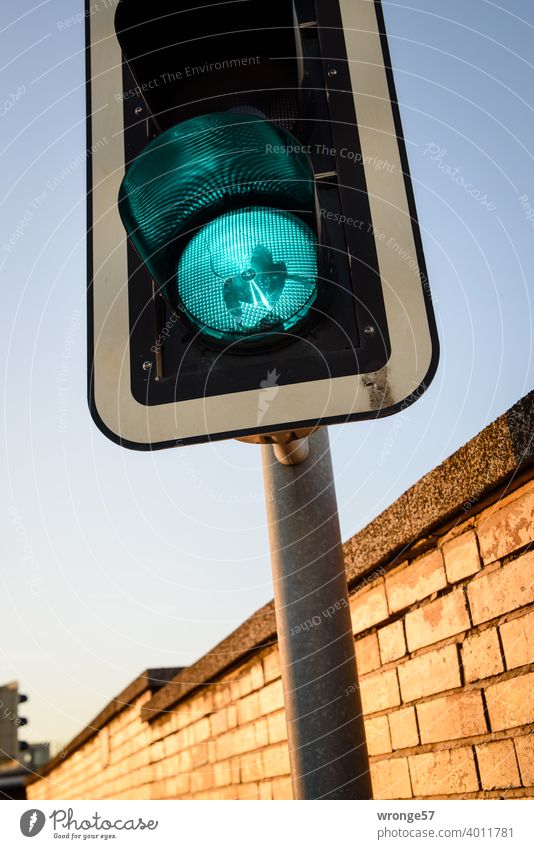 Traffic light with defective glass shows green Green Transport Traffic light regulation Road traffic Road sign Exterior shot Colour photo Street Crossroads