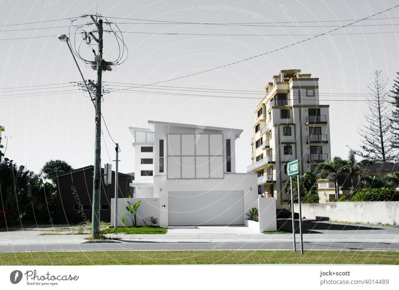 Luxurious villa with large garage Villa Modern architecture Luxury Street lighting Electricity pylon power line Tower block Facade Road marking Gold Coast