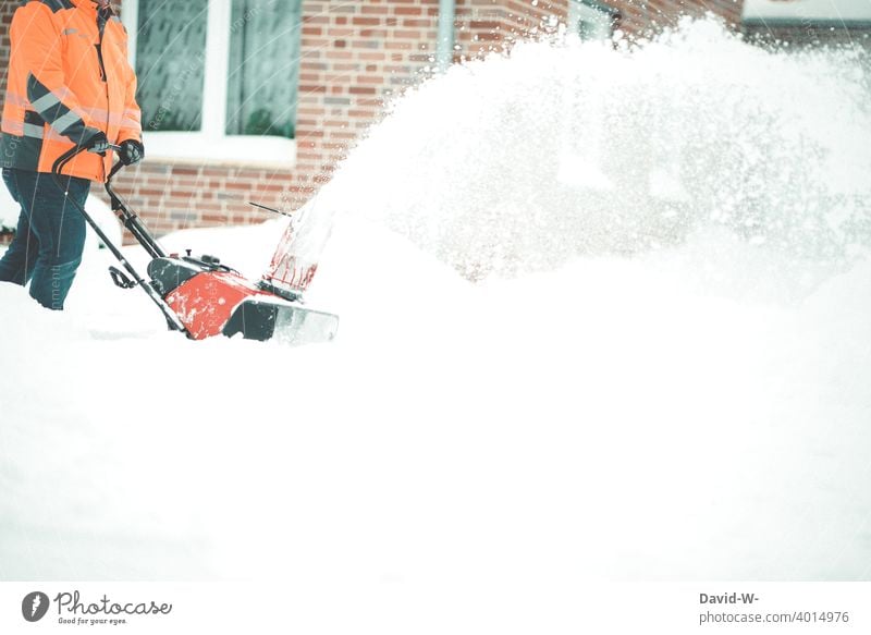 Man clearing snow aside with a snow blower in winter Snow masses a lot Winter maintenance program Storm warning Weather onset of winter off Snowfall White