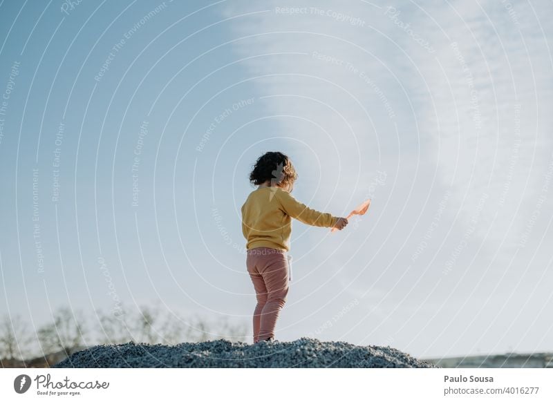 Child playing outdoors Rear view childhood Sunset Sky Copy Space Playing Childhood memory Toddler Joy Day Copy Space top Human being Exterior shot Colour photo