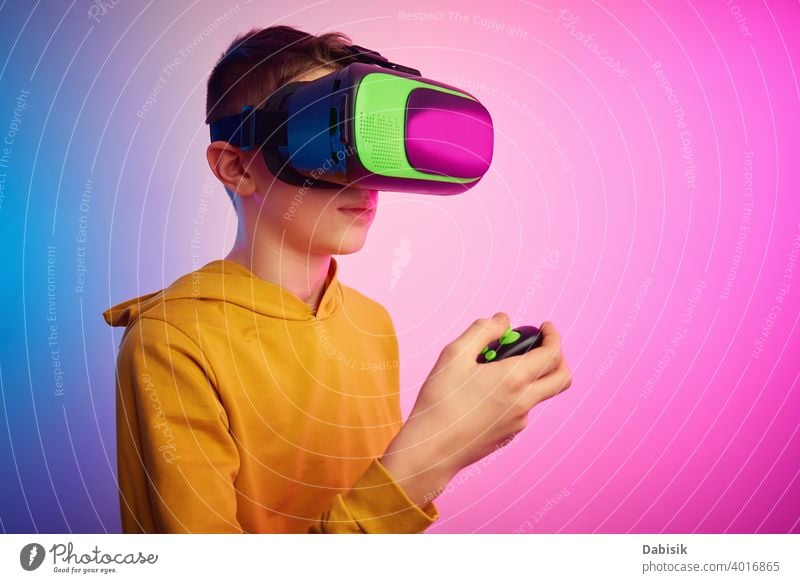 Boy with virtual reality glasses on colorful background. Future technology, VR concept vr headset boy helmet device game future video experience wearable