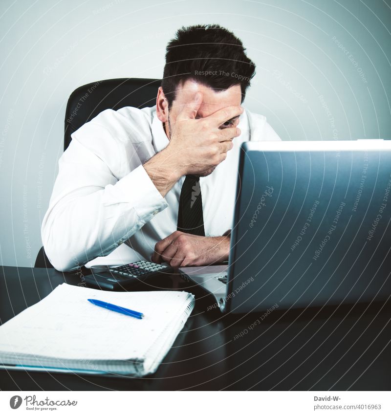 anxious businessman in front of laptop holds his hand in front of his face anxiously Man Notebook Fiasco shocked Fear Business home office Desk labour Office