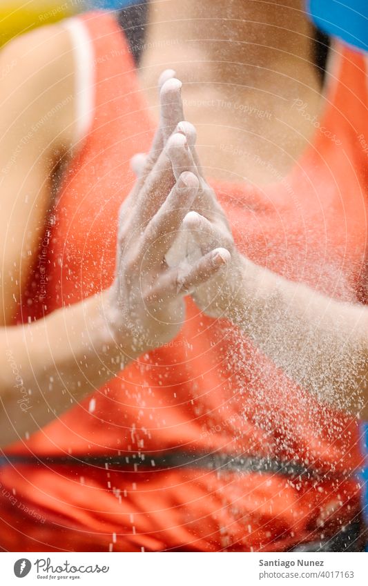 Rock climber chalking her hands. sport training climbing rock wall leisure extreme unrecognizable anonymous faceless magnesium bouldering activity fitness