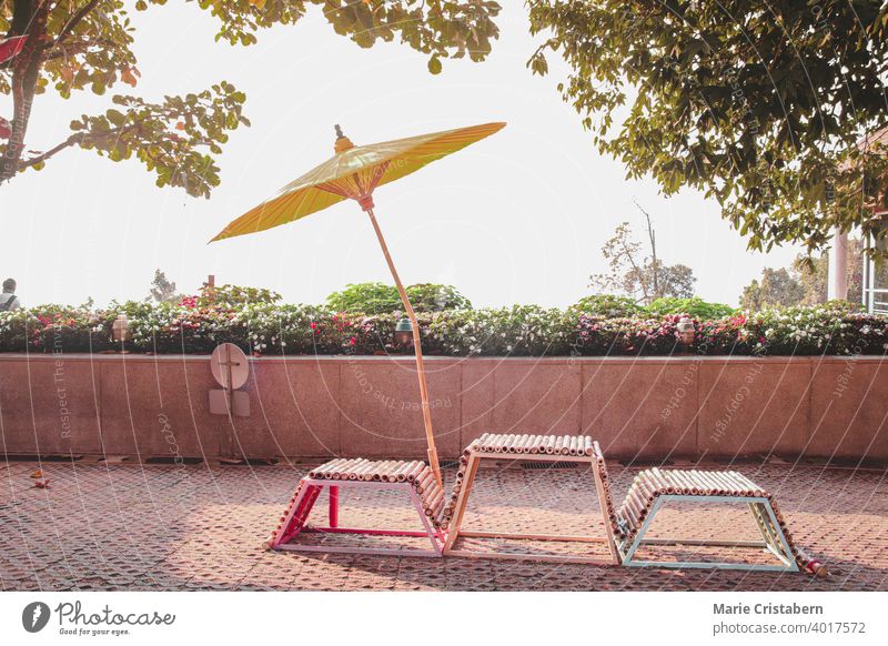 Chairs and a yellow Japanese umbrella on a summer day japanese umbrella japanese style oriental design asia chair garden tropical holiday vacation park outdoor