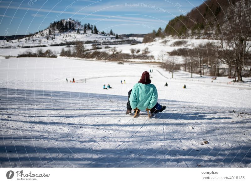 Sledding in the winter on the Swabian Alb children fun Alps Skiing white background Sun Swabian Jura White Snow Winter Powder snow Forest Sunlight Ski run