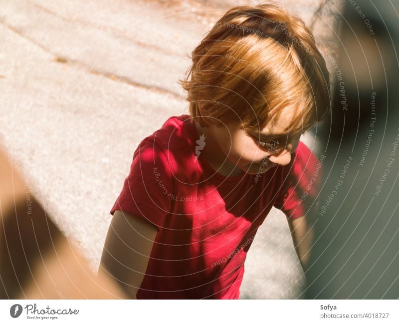 Little boy playing outdoors in summer lifestyle child authentic kid freedom bike nature face smiling sun fun little portrait cute joy blonde sunlight caucasian